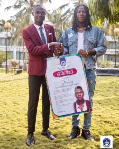 H.E the president/CEO of PUSAG Alswel Annan doing the presentation to Stonebwoy 