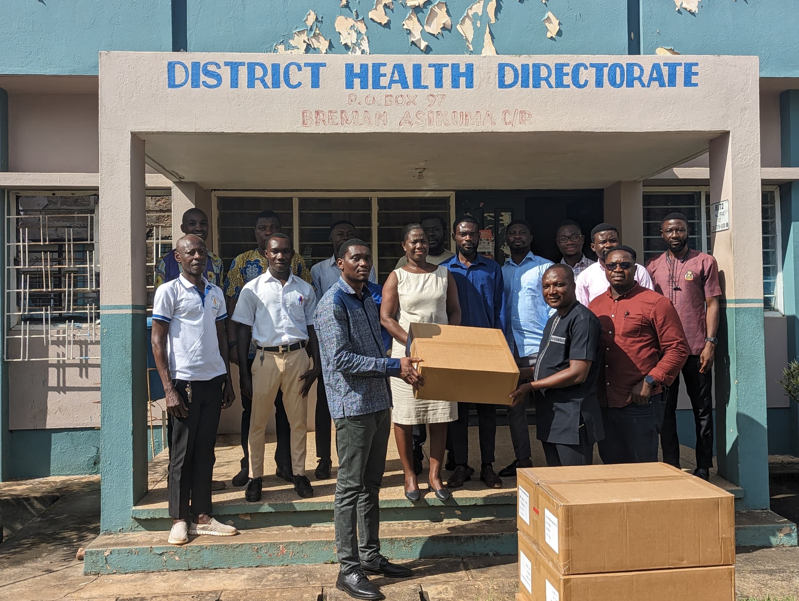 The CEO, Mr Apraku presenting boxes of glucometers to the district health director 